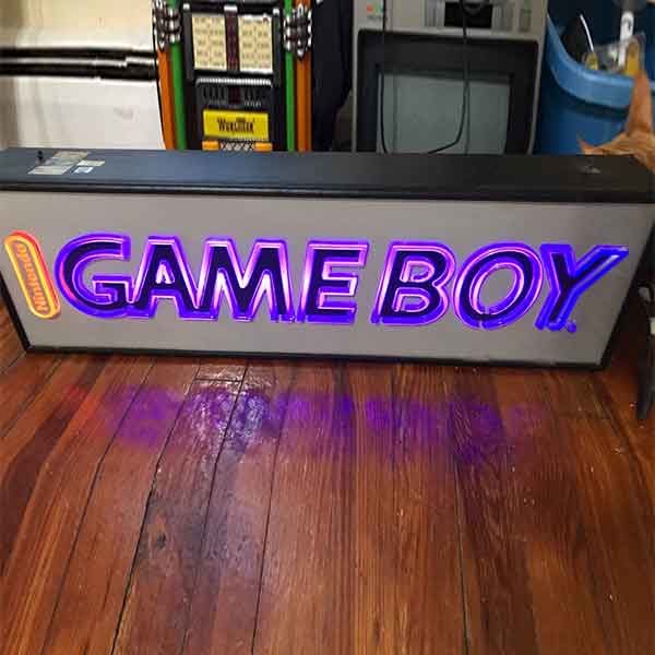 The Game Boy Light Up Store Sign glows in a very vintage purple