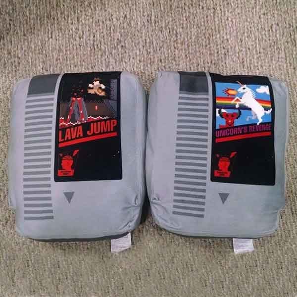 Two gray pillows that look like NES cartridges