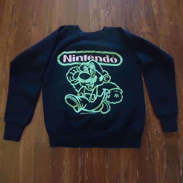 Get noticed when you walk into the club with this one of a kind glow in the dark Mario sweater.